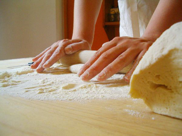 Making homemade pasta dough by hand on kitchen counter