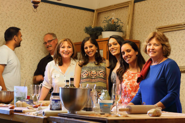 Friends participating in hands-on cooking workshop together